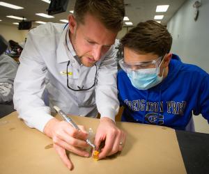 Professional giving dental instruction to young person