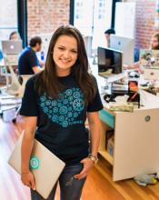 Erin Coburn, a Creighton alumni, standing in the Flywheel office