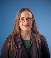 Charise Alexander Adams (brown-haired white female with glasses): headshot