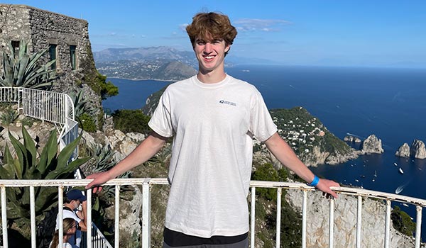 JJ Smith on balcony overlooking the sea in Rome