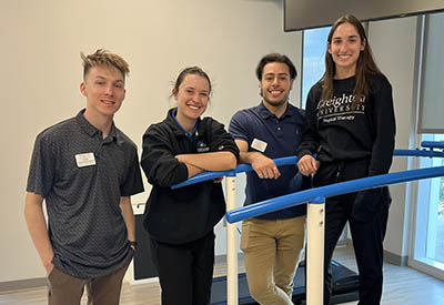 Staff members posing together in physical therapy room.