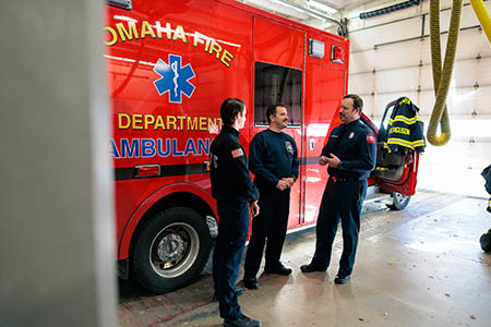 Paramedic engagement around ambulance.