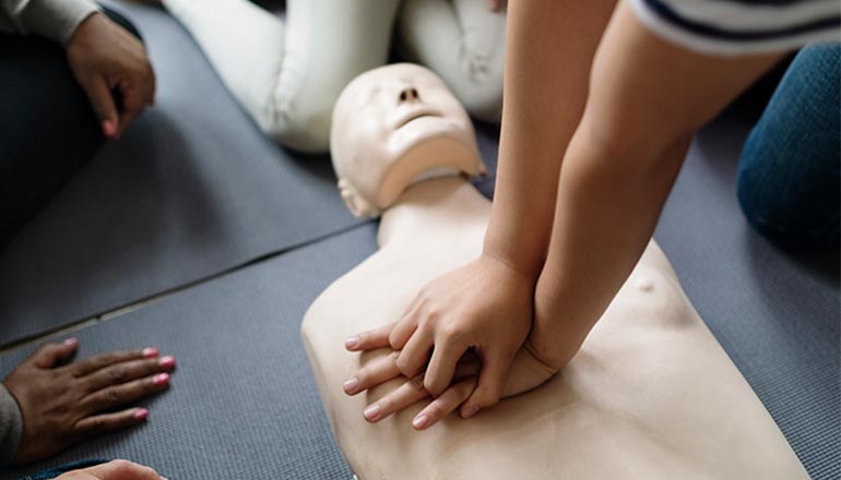 AHA Instructor performing chest compressions