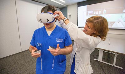 Student with lab assistance for VR.