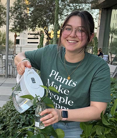 Madeline Trotter watering plants.