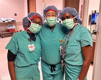 Patricia Belle with colleagues in scrubs