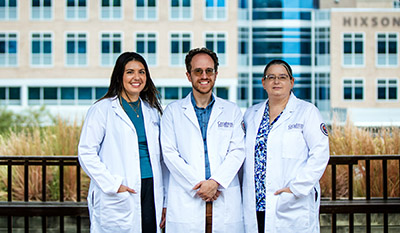 Grant partners pose in white coats.