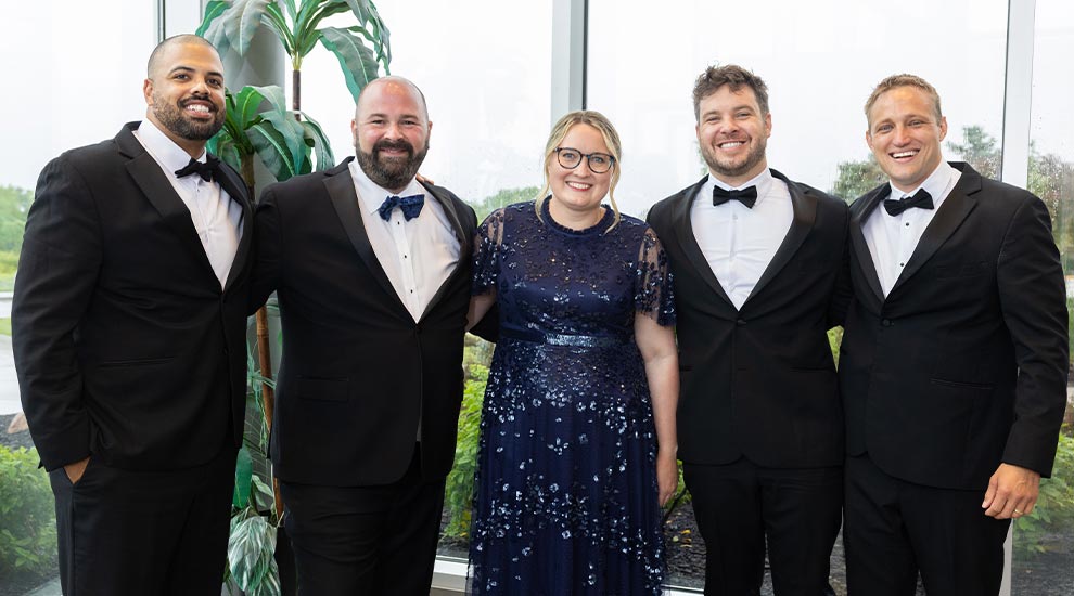 2026 General Surgery Residency graduation photo featuring five residents in formal evening wear celebrating their completion of the program.