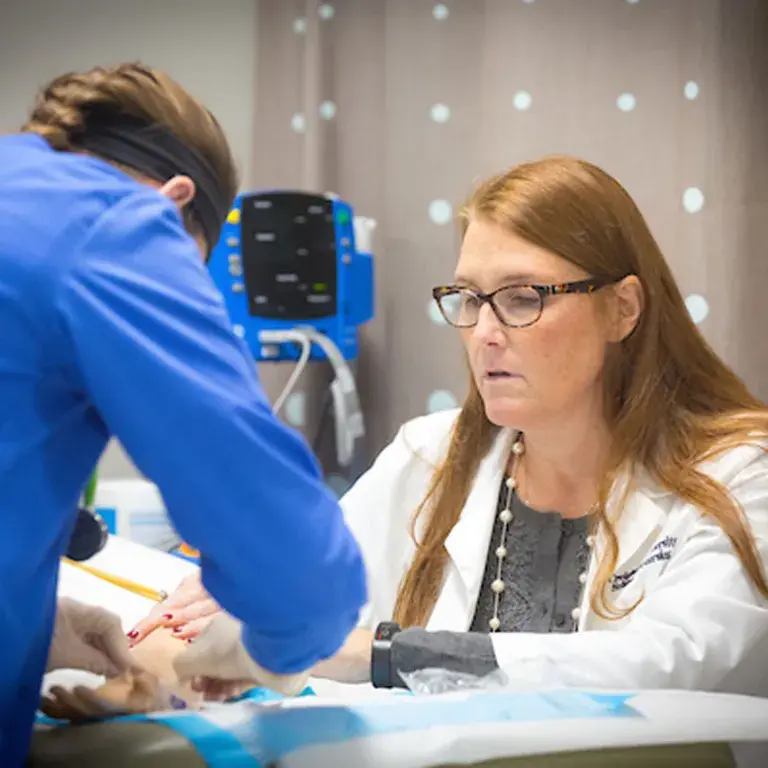 Two nurses performing a procedure