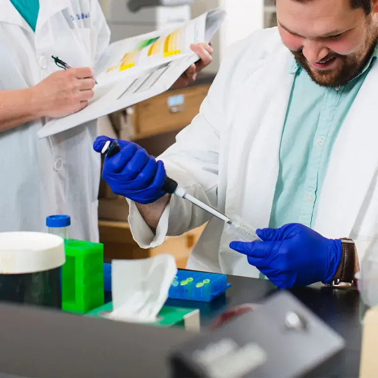 Scientists with samples in a lab