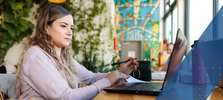 Young woman at table with laptop