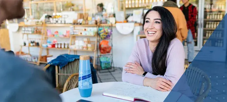 Young woman at table smiling
