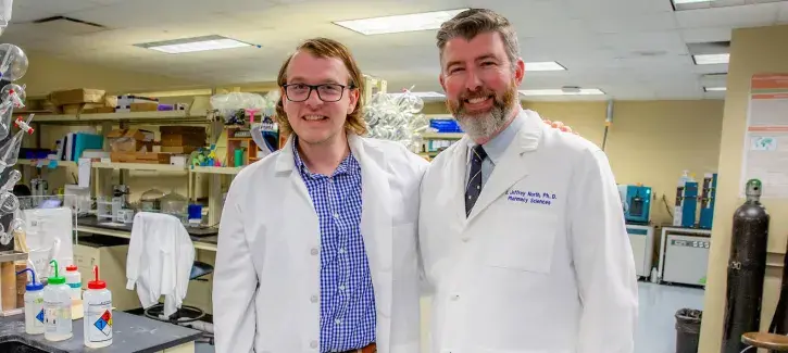 Daniel Kohl with Jeffrey North in lab setting.
