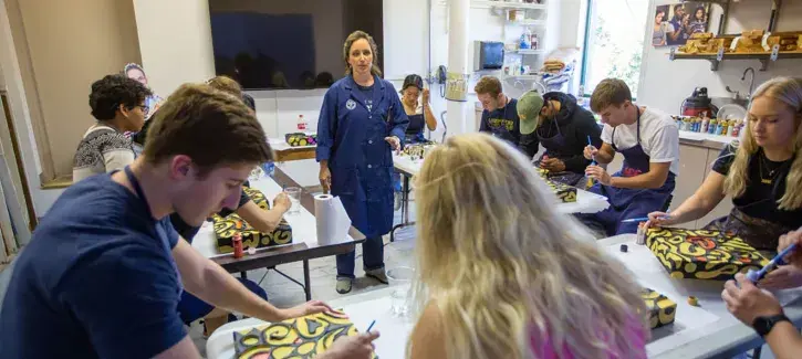 Students working on art project in class setting.
