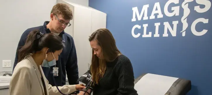 Take patient blood pressure at Magis Clinic.