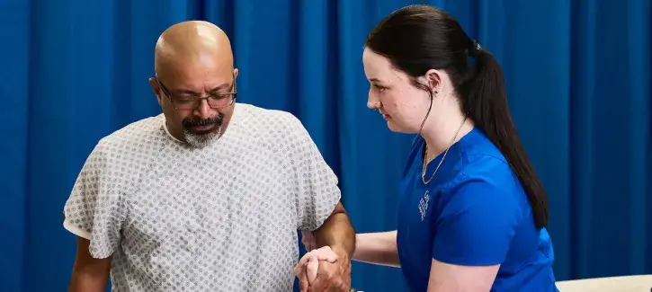 Nursing student assisting patient