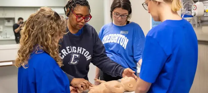 Nursing educational class working on infant care.