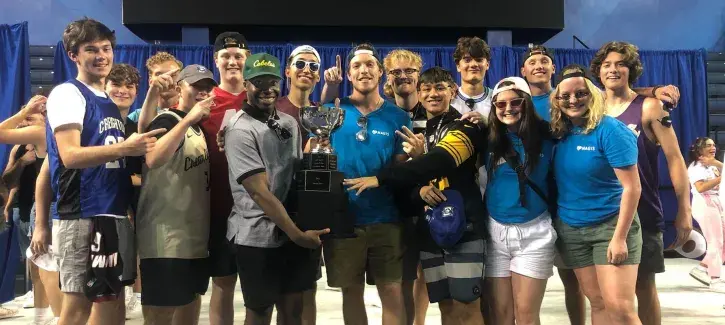 Shafack holding trophy with team members.