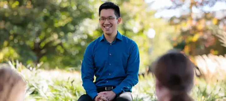 Tom Wong discussing material outside with students.