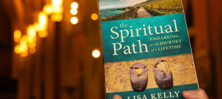 Lisa Kelly holds her book
