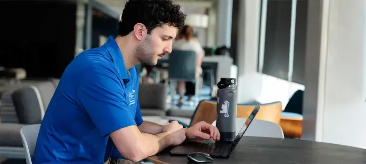 Man sitting at table and looking at computer