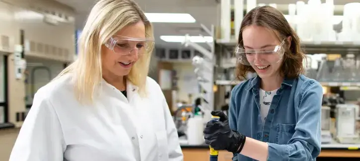 Strauss-Soukup works with student in lab setting.