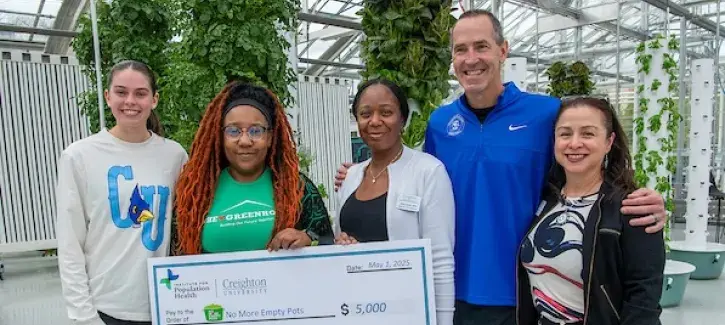 Creighton Women's Basketball and IPH donate $5,000 to No More Empty Pots