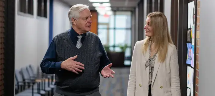 Law Professor R. Collin Mangrum, JD, SJD, and law student meet in the School of Law