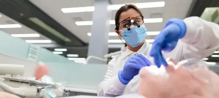 Dentist working on patient at Creighton.