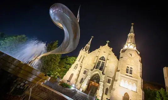 Night view of St. John's Church with fountain in foreground