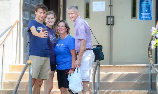 student taking a family picture