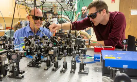 Dr. Wrubel and student adjusting optics