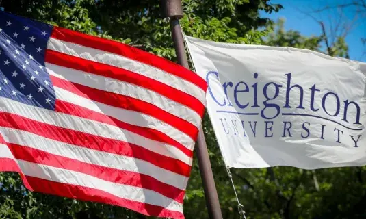 American flag next to Creighton University flag