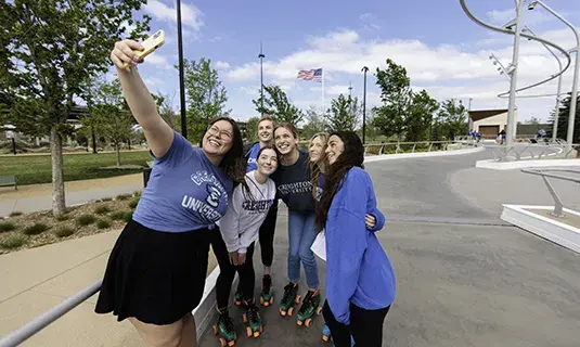 Creighton students gathered outside and taking a selfie.