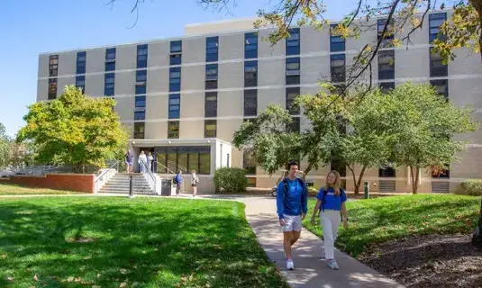 Students walking in front of residence hall.