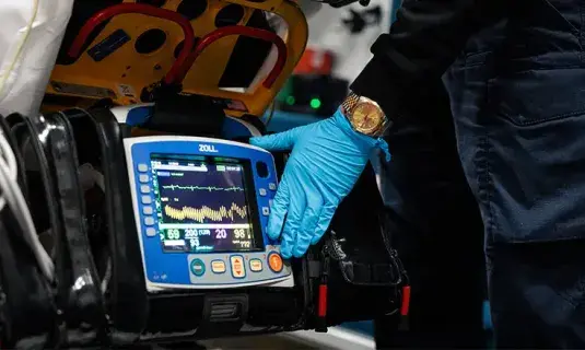 EMT working opening medical bag.