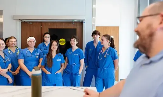 Nurses gathered in room with instructor.
