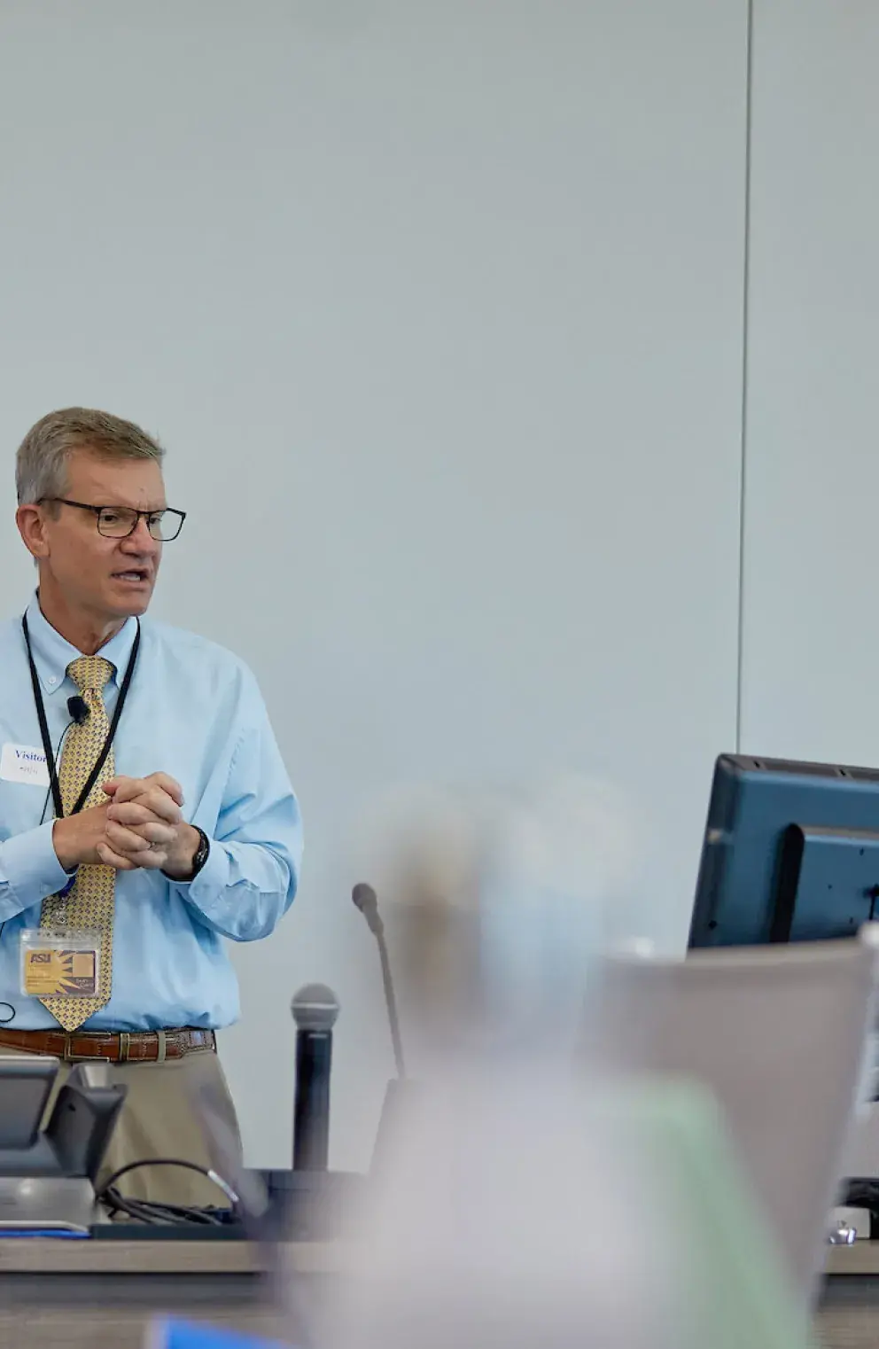 Instructor in white coat teaching students in the classroom