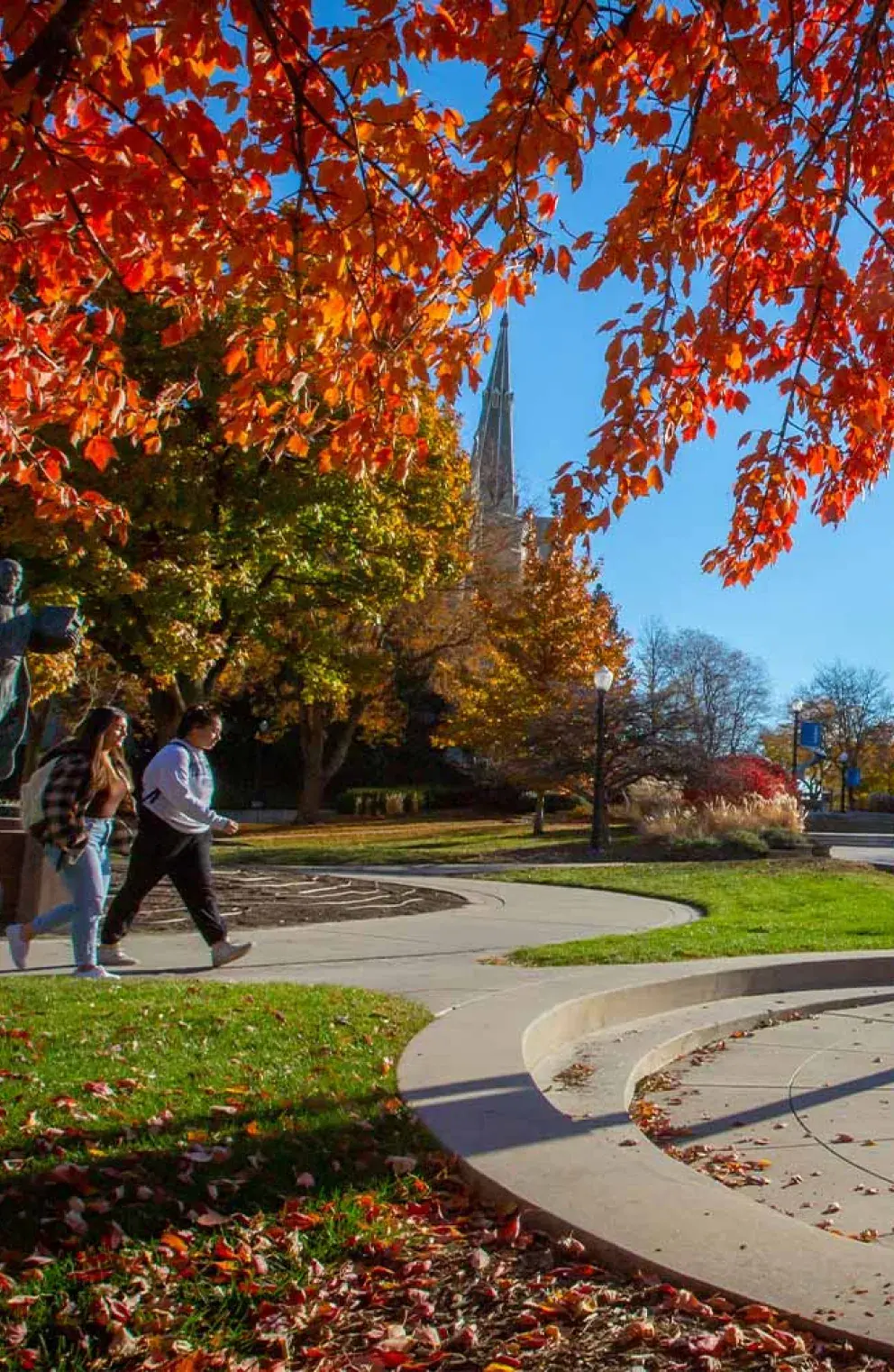 Fall foliage on Creighton's campus by the St. Ignatius statue