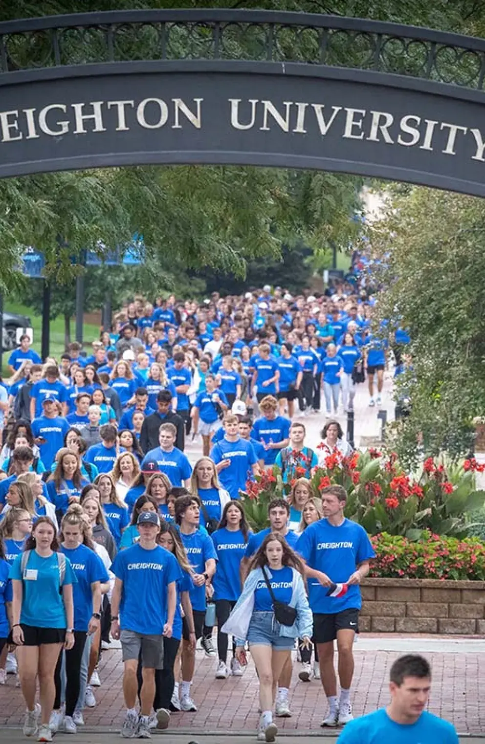 The new freshmen class passes under the Creighton archway.