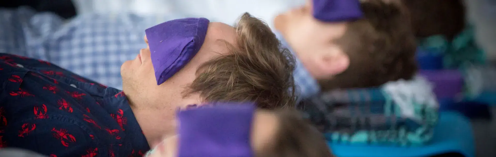 Yoga students wearing eye masks