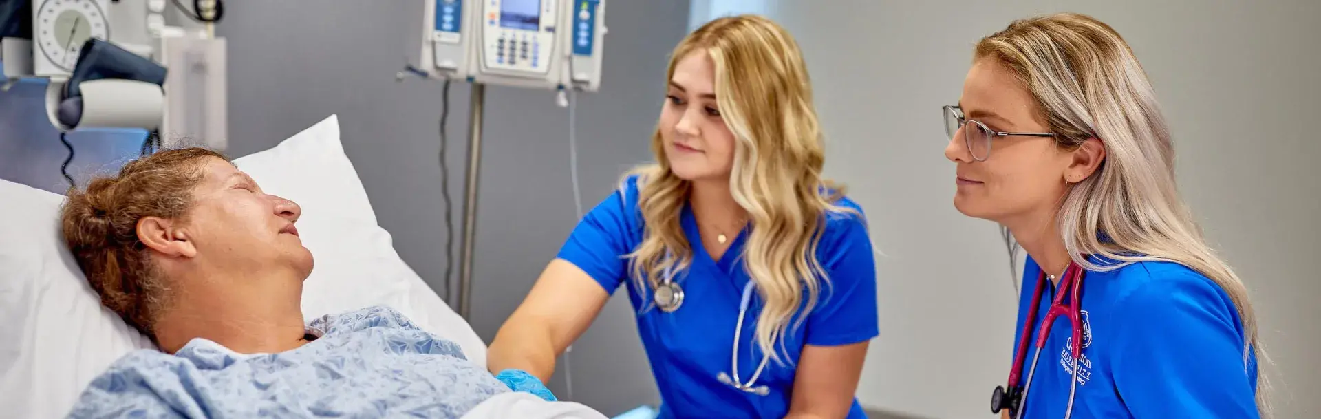 Nurses with patient in skills lab