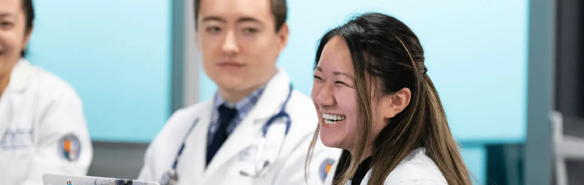 med students with laptops at table