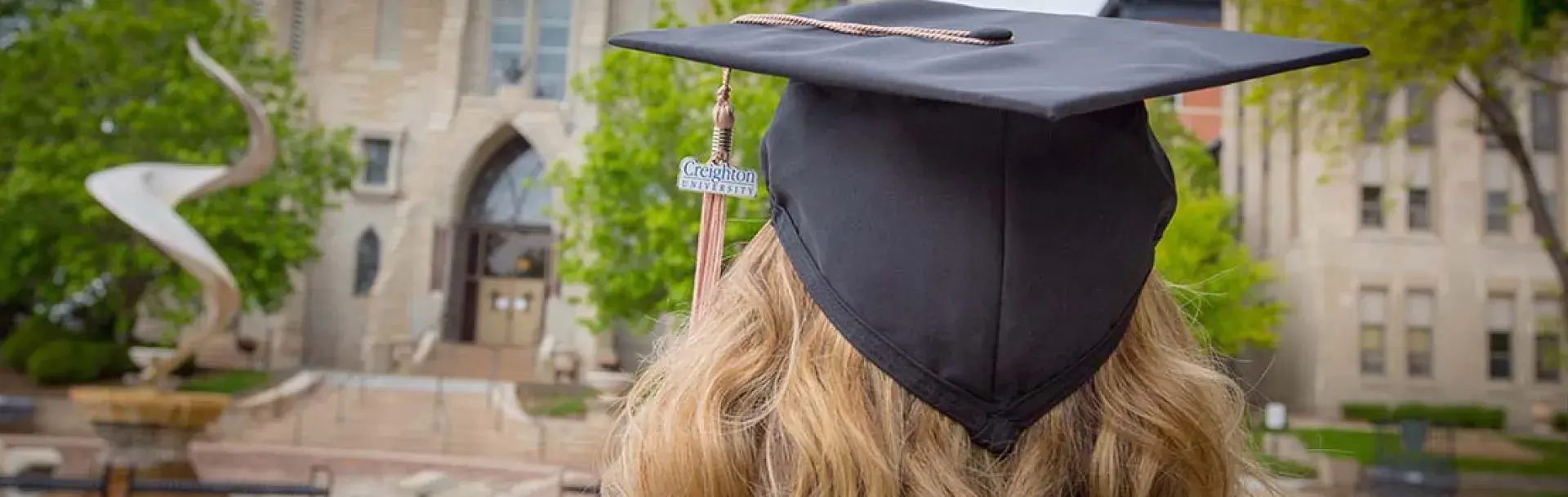 Heider College of Business graduate wearing cap with Creighton university