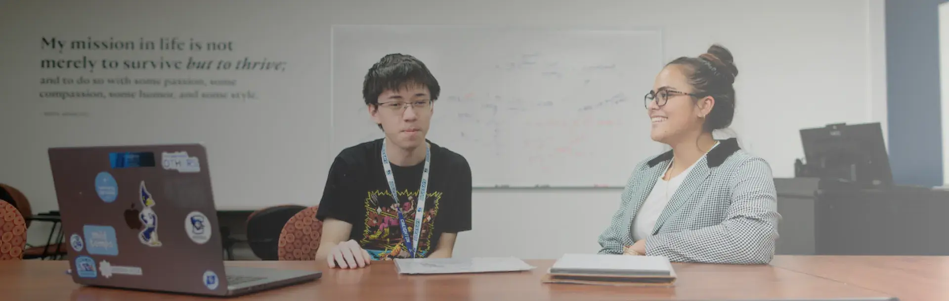 Student talking to staff member