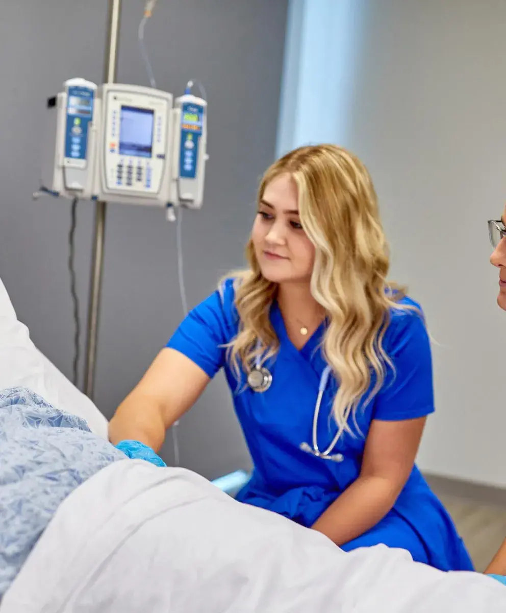 Nurses with patient in skills lab