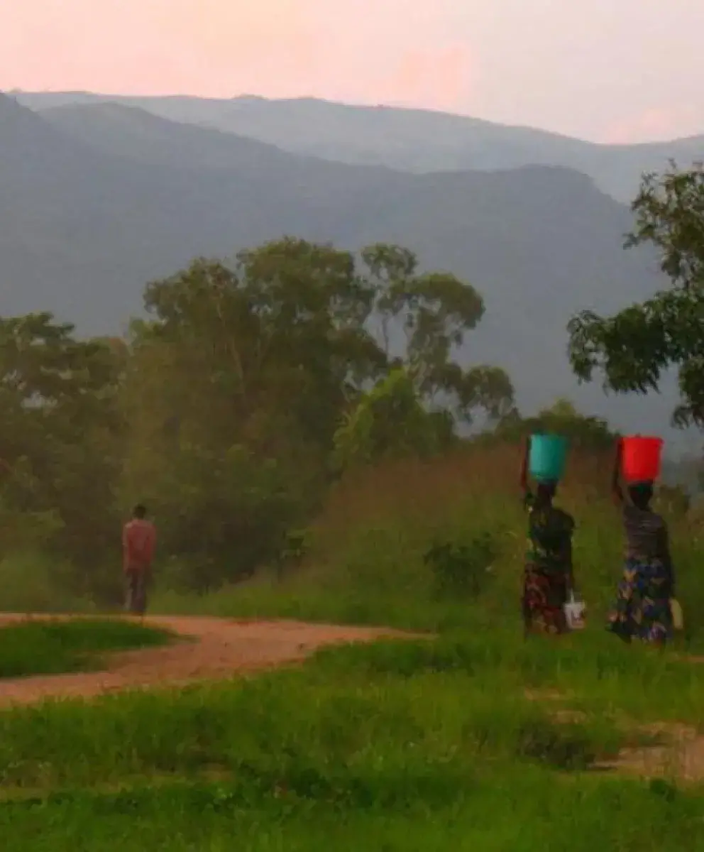 African women carrying water on their heads.