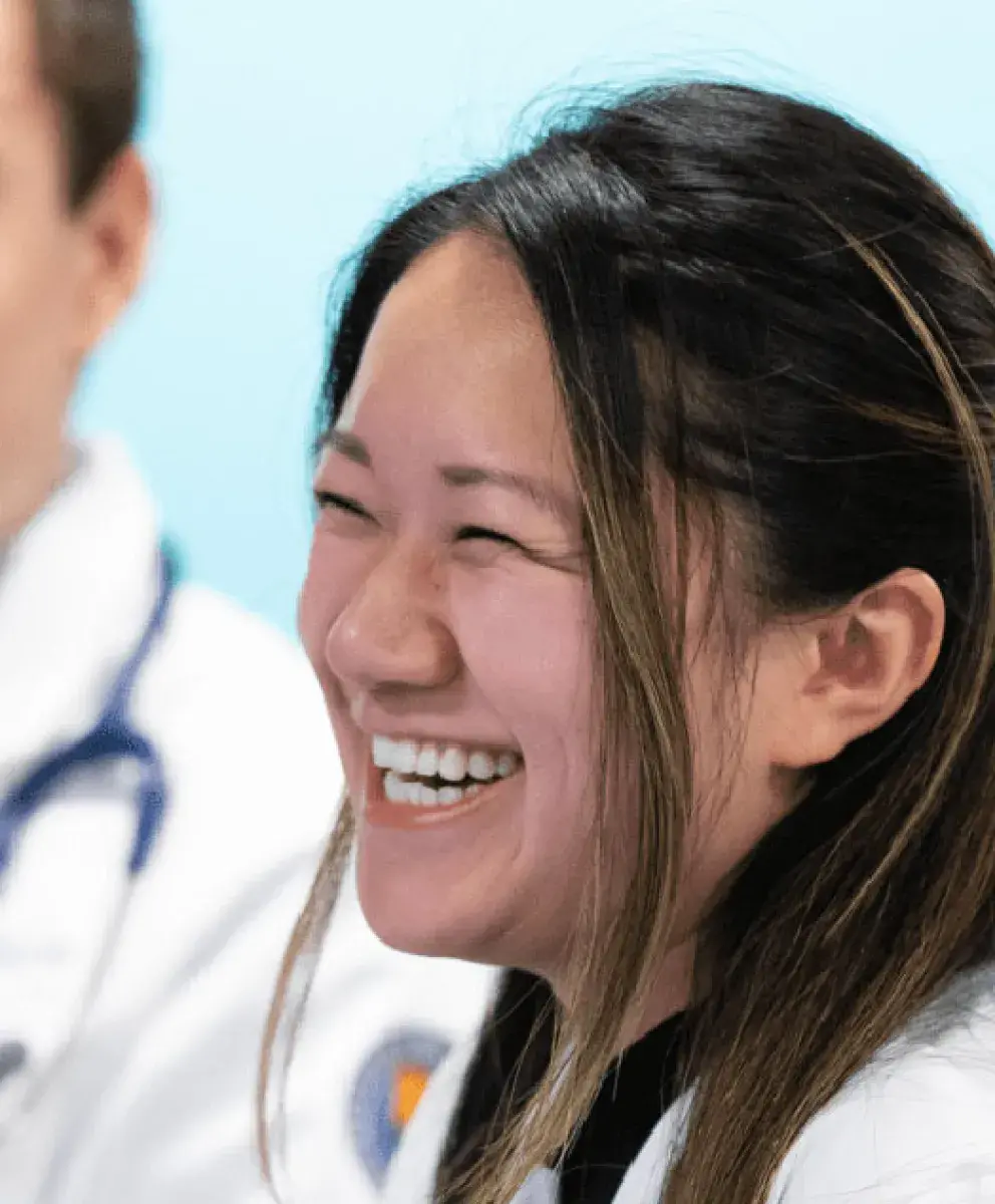 med students with laptops at table