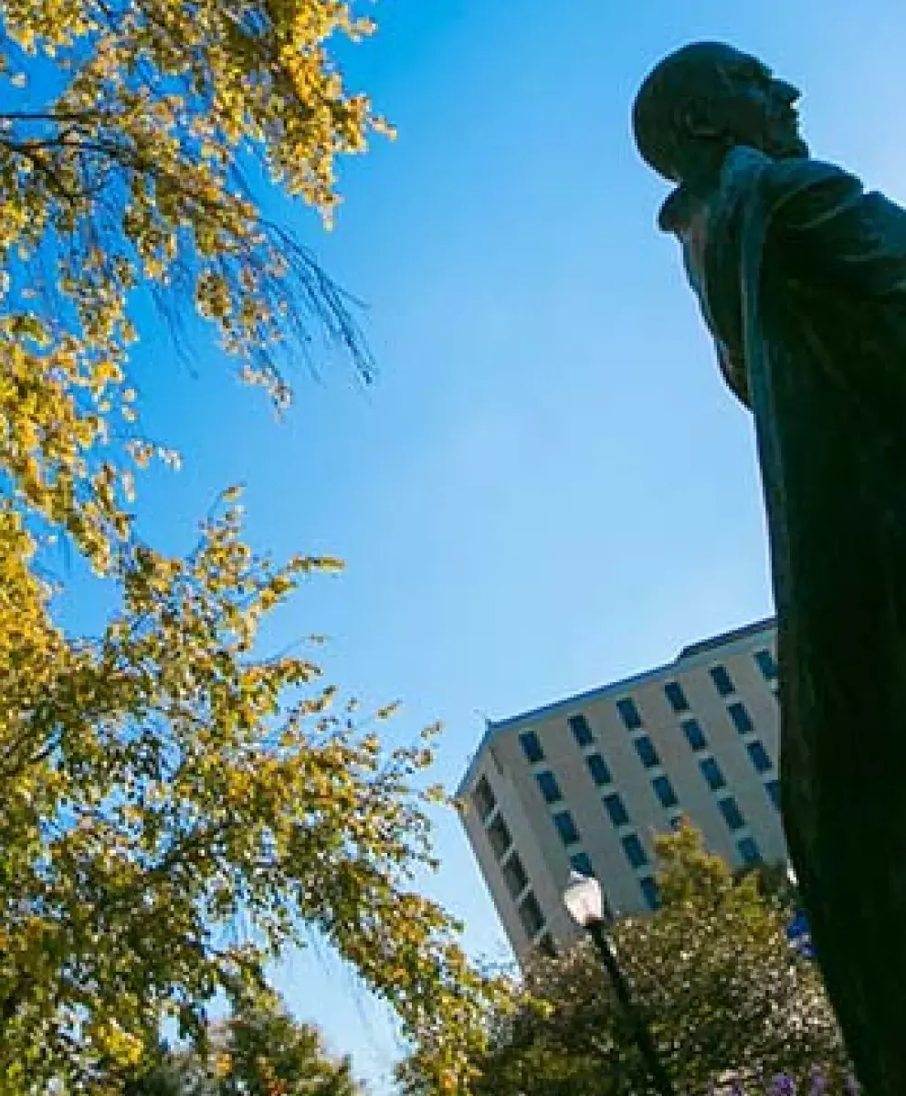 Jesuit statue in early morning sunlight.