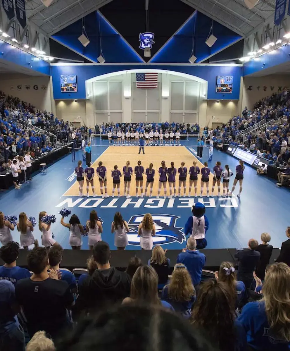 Bluejay volleyball game with teams and fans